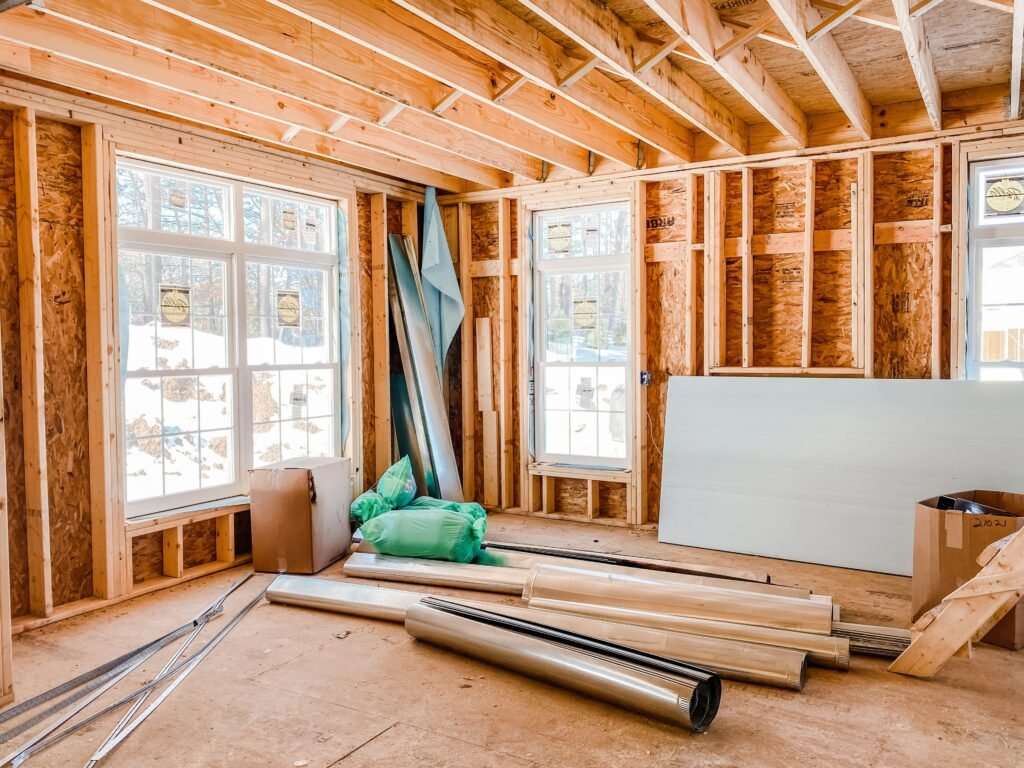 Construction materials stacked on the floor inside a house under construction
